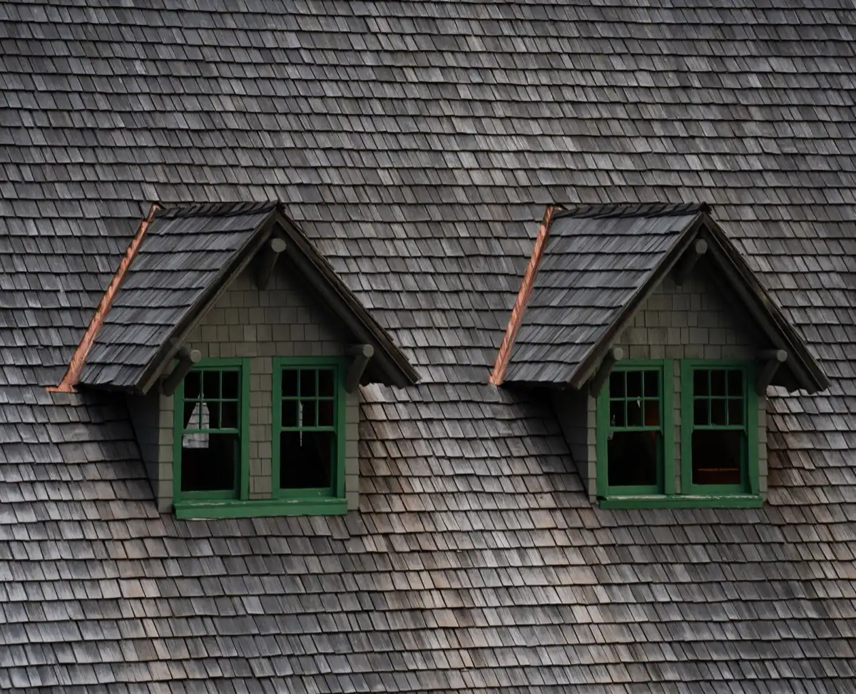 Dormers on a shingle roof in Provo, UT, where step flashing and kickout flashing carry water past the walls